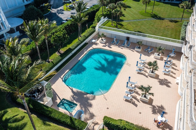 pool featuring a patio area, outdoor dining space, and a fenced backyard