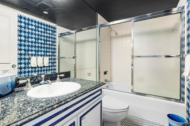 bathroom with tile patterned flooring, visible vents, toilet, combined bath / shower with glass door, and vanity