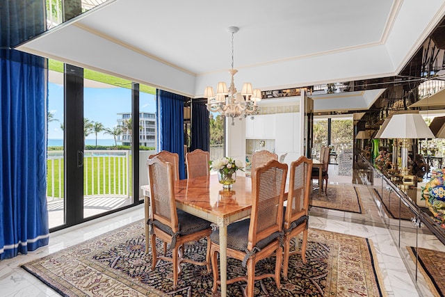 dining room with an inviting chandelier, marble finish floor, and ornamental molding