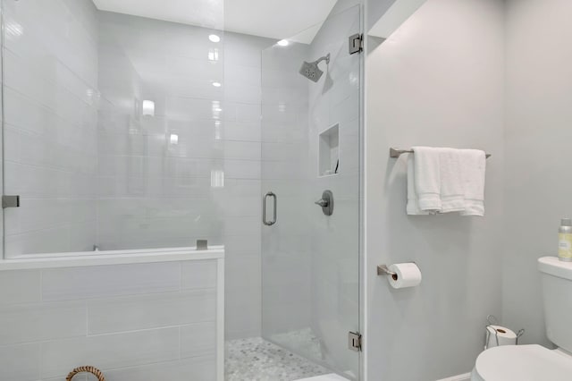 full bath with a stall shower and toilet