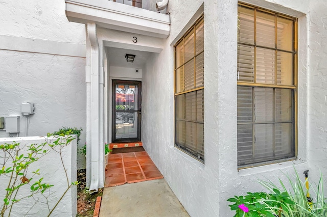 property entrance featuring stucco siding