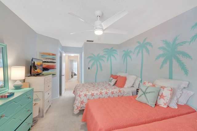 bedroom featuring ceiling fan, visible vents, a textured ceiling, and light colored carpet