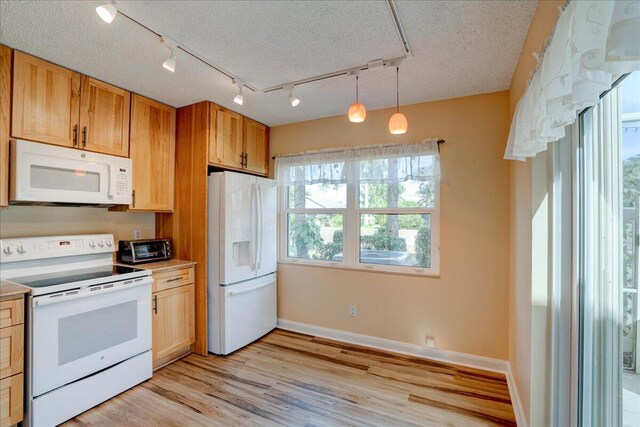 kitchen featuring white appliances, baseboards, light wood-style flooring, hanging light fixtures, and a textured ceiling