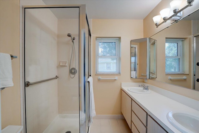 full bathroom with a sink, a shower stall, and baseboards