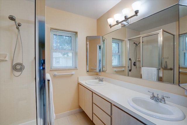 bathroom featuring a healthy amount of sunlight, a sink, and a shower stall