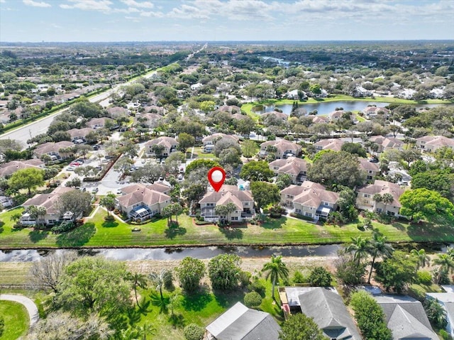 drone / aerial view featuring a residential view and a water view