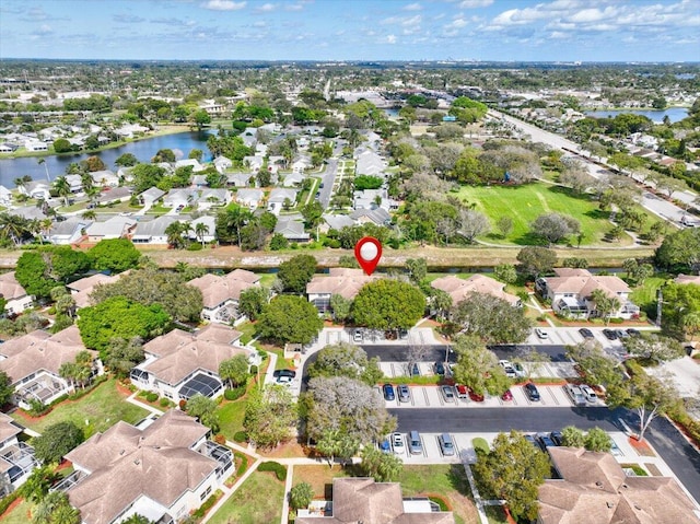 drone / aerial view featuring a water view and a residential view