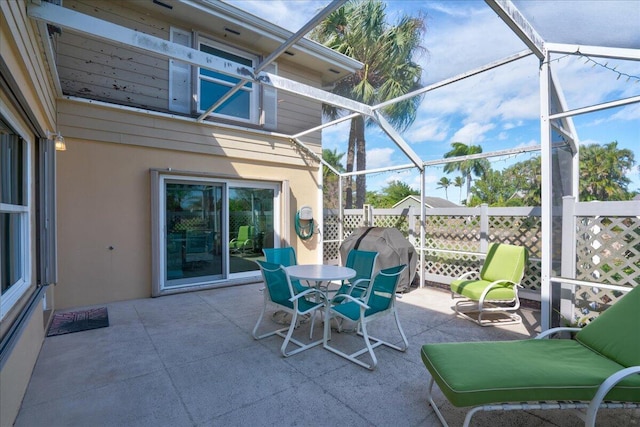 view of patio featuring outdoor dining space, a lanai, and grilling area