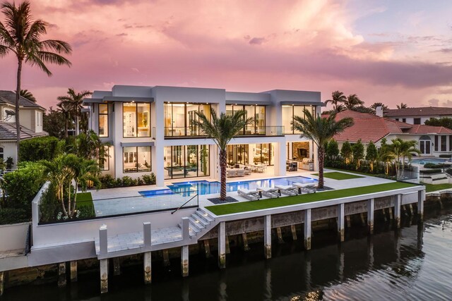 contemporary house featuring decorative driveway, a fenced front yard, and stucco siding