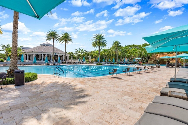 pool with a patio area and a gazebo