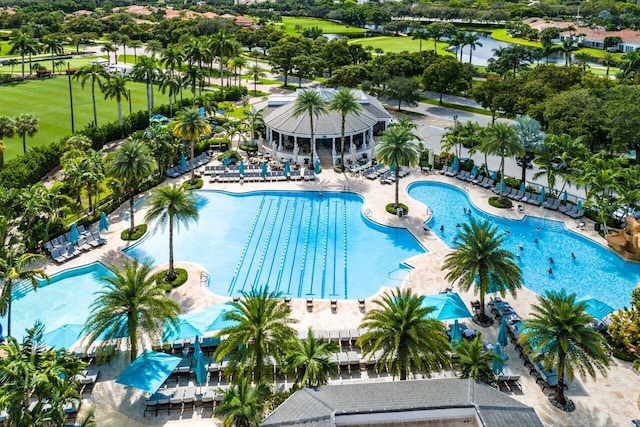 view of swimming pool with a patio area and a water view