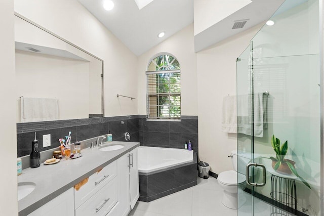 full bath with a stall shower, visible vents, lofted ceiling, a garden tub, and a sink