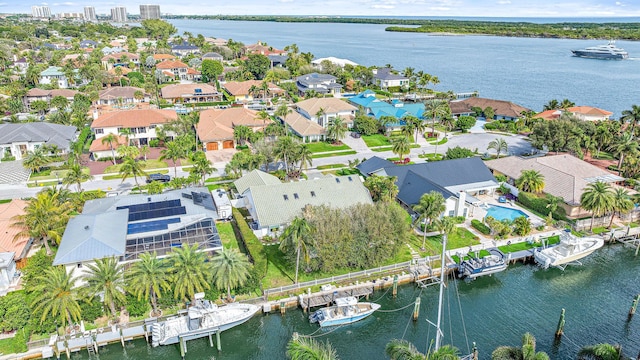 birds eye view of property with a water view and a residential view