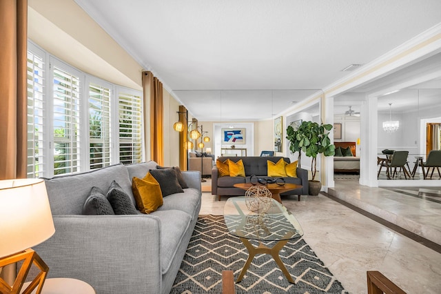 living room with marble finish floor, visible vents, a chandelier, and ornamental molding