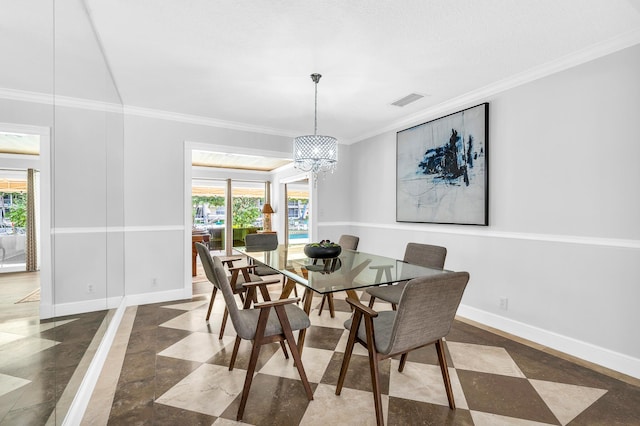 dining space featuring a chandelier, visible vents, crown molding, and baseboards