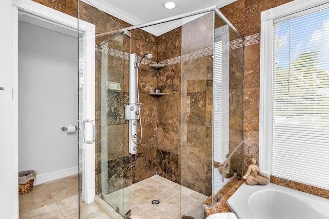 bathroom featuring a stall shower, crown molding, baseboards, and a bath