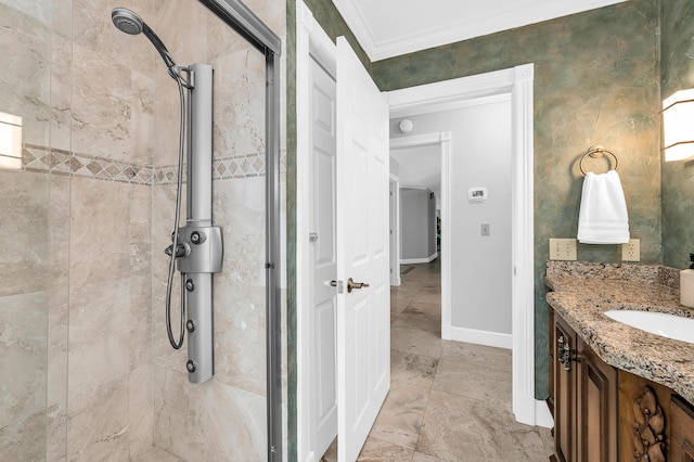 bathroom featuring ornamental molding, a shower stall, vanity, and baseboards