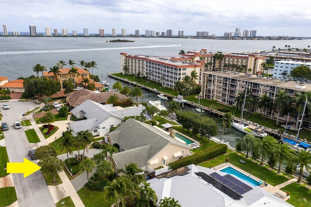 birds eye view of property with a view of city and a water view