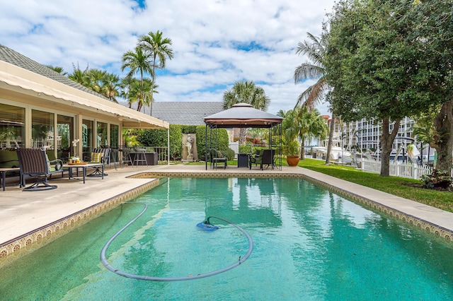 pool featuring a gazebo, a patio, and fence