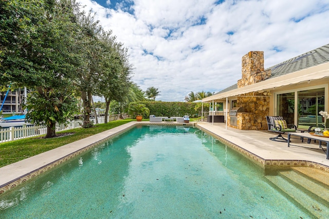 outdoor pool featuring a patio and a fenced backyard