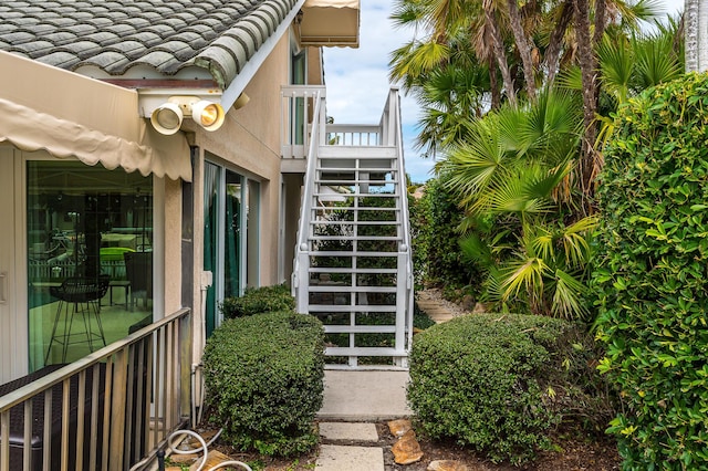 doorway to property with stucco siding and a tiled roof