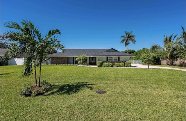 single story home with a front yard and fence