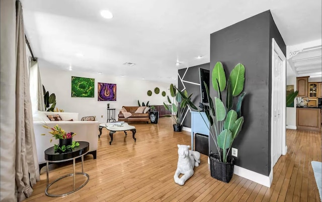 living area with light wood finished floors and baseboards