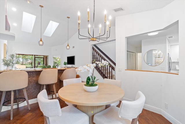 dining room with visible vents, stairway, baseboards, and wood finished floors