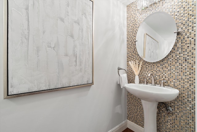 bathroom with baseboards and a sink