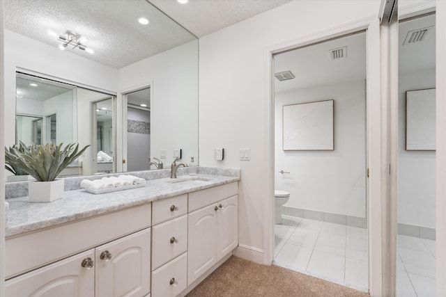 full bathroom with visible vents, a textured ceiling, vanity, and toilet