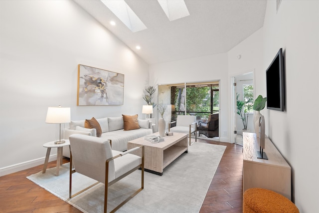 living area with high vaulted ceiling, a skylight, wood-type flooring, and baseboards