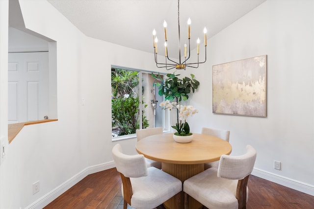 dining space featuring baseboards, vaulted ceiling, and wood finished floors