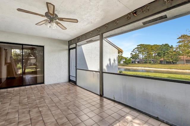 unfurnished sunroom with a water view