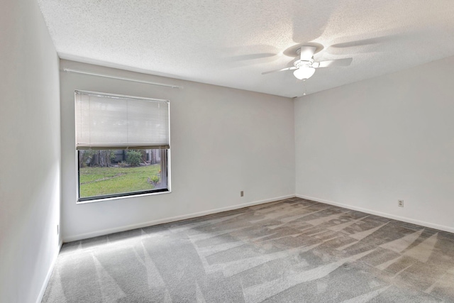 carpeted empty room with a textured ceiling, baseboards, and ceiling fan