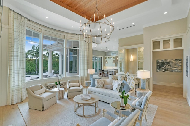 living room with wooden ceiling, recessed lighting, wood finished floors, a raised ceiling, and an inviting chandelier