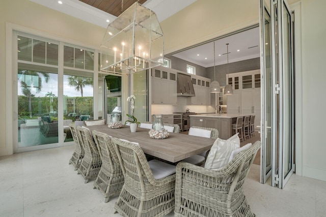 dining area featuring a high ceiling, a notable chandelier, and recessed lighting