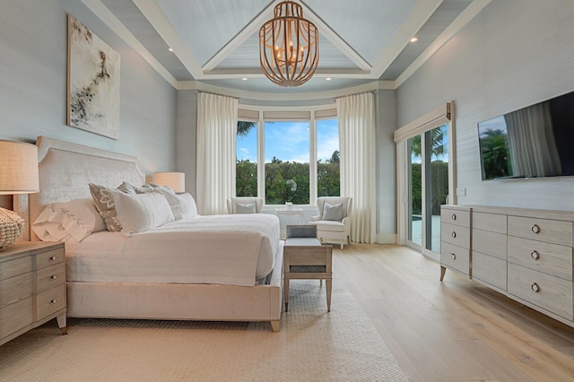 bedroom featuring a raised ceiling, wood finished floors, access to exterior, an inviting chandelier, and recessed lighting