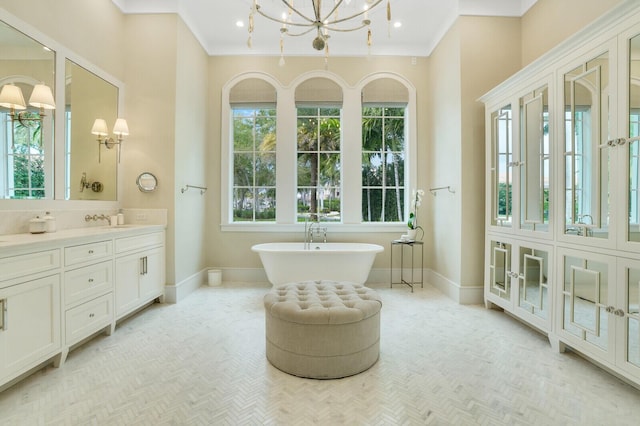 full bathroom with a soaking tub, baseboards, ornamental molding, and vanity