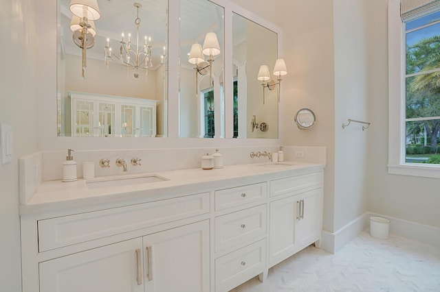 full bathroom featuring double vanity, baseboards, and a sink