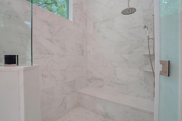 bathroom with a marble finish shower