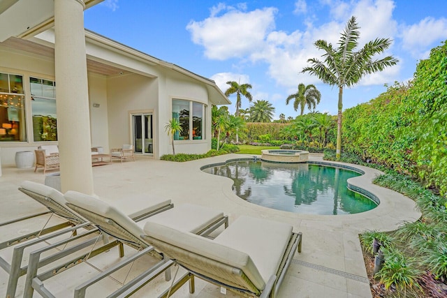 view of swimming pool with a pool with connected hot tub and a patio