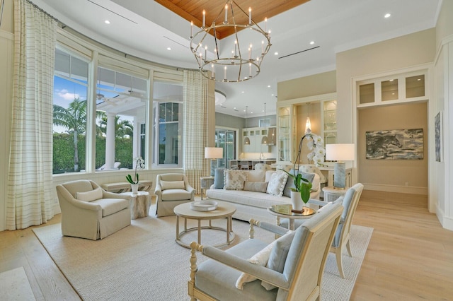 living area with recessed lighting, an inviting chandelier, baseboards, and wood finished floors