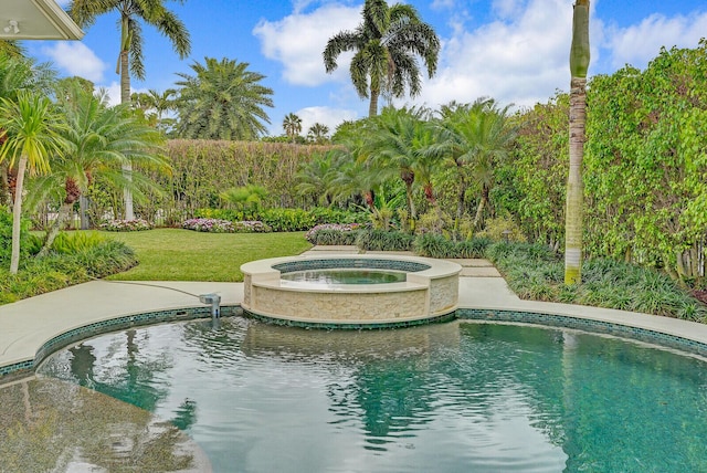 view of swimming pool with a yard and an in ground hot tub