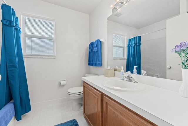 bathroom featuring visible vents, vanity, toilet, and baseboards