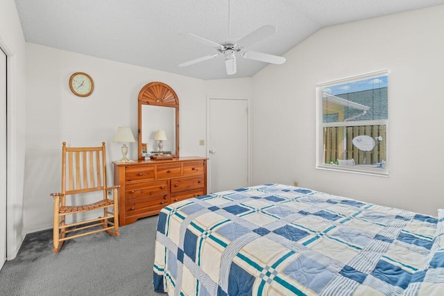 bedroom featuring carpet floors, lofted ceiling, ceiling fan, and a textured ceiling