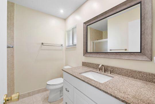 full bathroom with tile patterned flooring, toilet, recessed lighting, an enclosed shower, and vanity