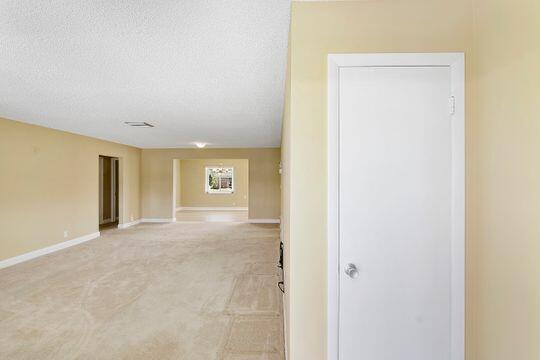 empty room with baseboards and a textured ceiling