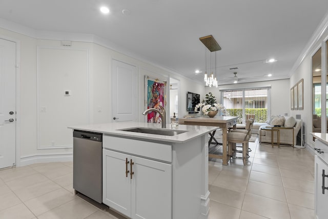 kitchen featuring light tile patterned floors, dishwasher, ornamental molding, open floor plan, and a sink