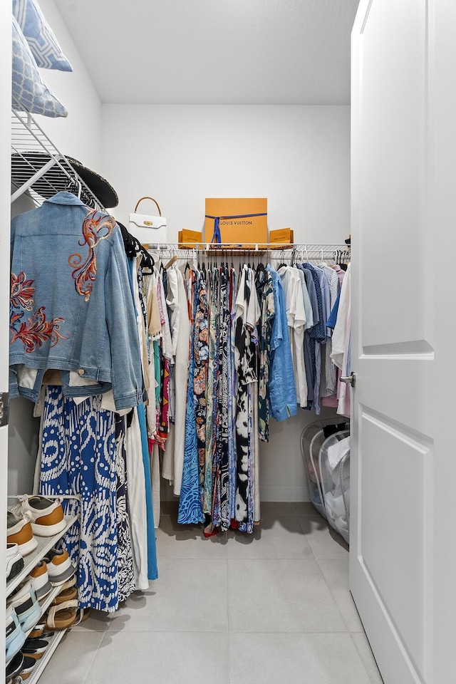 spacious closet with tile patterned floors