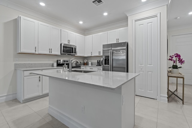 kitchen with light tile patterned floors, visible vents, white cabinets, appliances with stainless steel finishes, and a sink